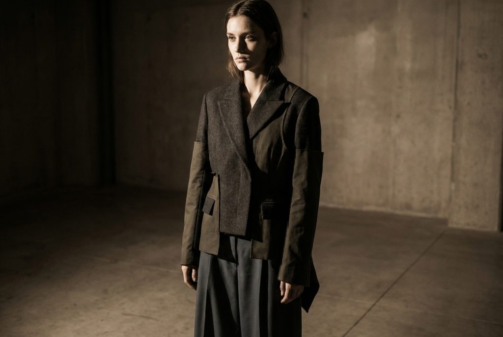 Model posing while the photographer captures the scene with the best camera for fashion photography