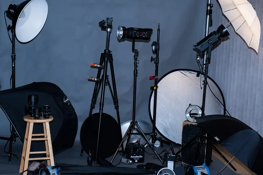 Photography studio equipment list including camera, lighting, and background system